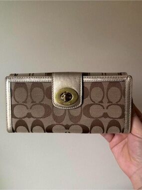 coach brown signature canvas turnlock wallet with metallic trim